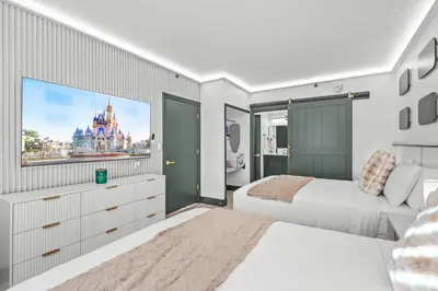 a bedroom with two beds and a flat screen tv at Cozy 1BR near Universal International Drive in Orlando
