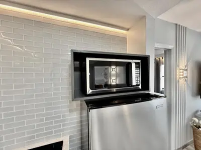 a microwave sitting on top of a refrigerator at Entire condo near Universal Studios in Orlando - Free Resort Access in Orlando