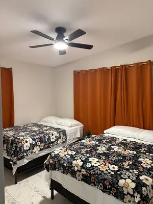 a bedroom with two beds and a ceiling fan at Game Day Getaway-Downtown Orlando in Orlando