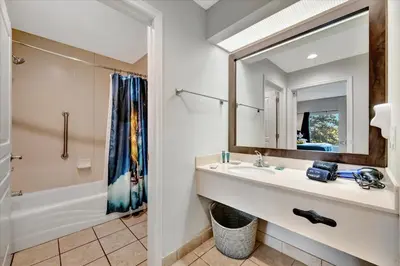 a bathroom with a sink and a mirror at FREE Shuttle & 50 Dollars Disney Gift Card Disney Resort Condo in Orlando