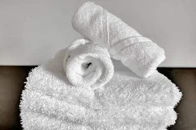 a roll of white towels sitting on a table at FREE Shuttle & 50 Dollars Disney Gift Card Disney Resort Condo in Orlando