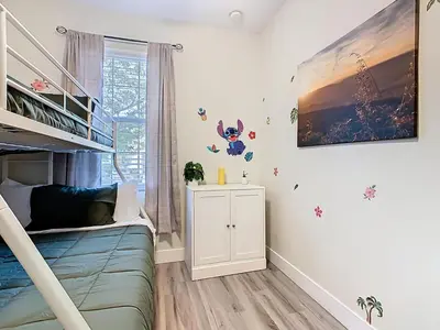 a childs room with a bunk bed and a shelf at 3BR Family-Friendly Town Home Near Disney in Orlando