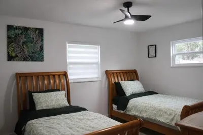 a bedroom with two beds and a ceiling fan at Spacious Casselberry Home Near Attractions in Orlando