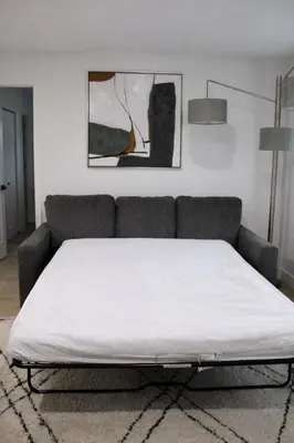a bed in a living room with a couch at Spacious Casselberry Home Near Attractions in Orlando