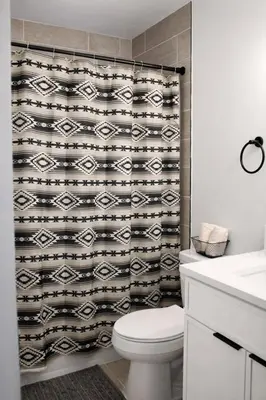 a bathroom with a toilet and a shower curtain at Spacious Casselberry Home Near Attractions in Orlando