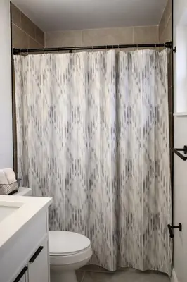 a bathroom with a shower curtain and a toilet at Spacious Casselberry Home Near Attractions in Orlando