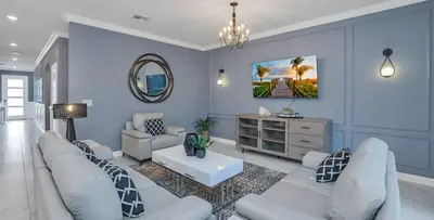 a living room with white furniture and a mirror at Pool & BBQ | Disney-Themed Cozy 6BD | Near Disney in Kissimmee