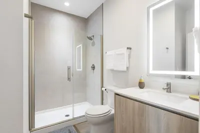 a bathroom with a shower and a toilet and a sink at A Magical and Cozy Family Getaway 3BR Home Near Disney Studios in Orlando