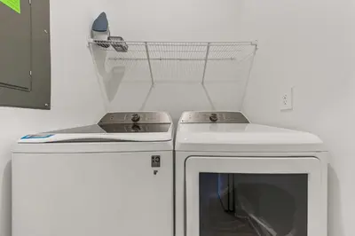 a laundry room with a stove and a washer at South-Facing Pool 5BR Storey Lake Lazy River 2437 in Kissimmee