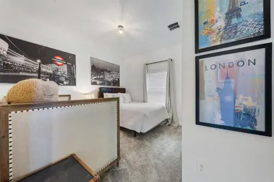 a bedroom with a bed and pictures on the wall at South-Facing Pool 5BR Storey Lake Lazy River 2437 in Kissimmee
