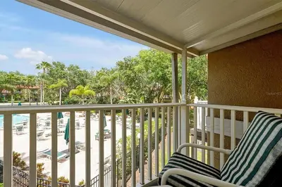 a balcony with two chairs and a view of the beach at 4BR Luxury Villa Private Pool & Slide Disney in Kissimmee