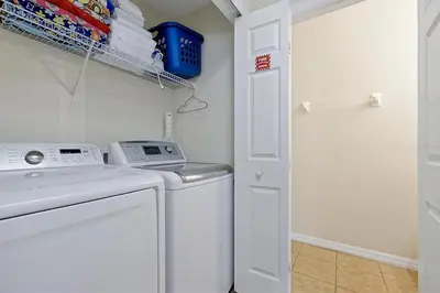 a white washer and dryer in a laundry room at 4BR Luxury Villa Private Pool & Slide Disney in Kissimmee