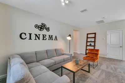 a living room with a couch and a chair at Classy 6BR Home with Private Pool in Kissimmee