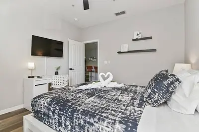 a bedroom with a bed with a heart on it at Restpool vibes, Nest tree-ish Retreat- NxtDisney in Kissimmee