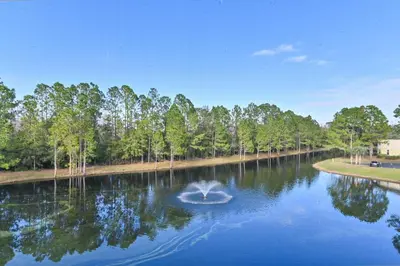 a pond with a fountain in the middle at Pause Discover something that nourishes your soul in Kissimmee