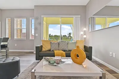 a living room with a couch and a table at Sunset every single day ReserveView 4BRElevator in Kissimmee