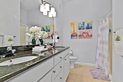 a bathroom with a sink and a toilet at Sunset every single day ReserveView 4BRElevator in Kissimmee