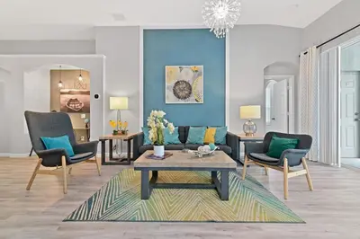 a living room with a couch and chairs and a table at Finest renovated w Pool, Game rm, 4 Mi to Disney in Kissimmee