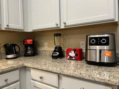 a kitchen counter with a blender and a coffee maker at SPECTACULAR CONDO only 4 Miles to Disney! in Kissimmee