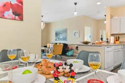 a table with glasses of wine and food on it at SPECTACULAR CONDO only 4 Miles to Disney! in Kissimmee