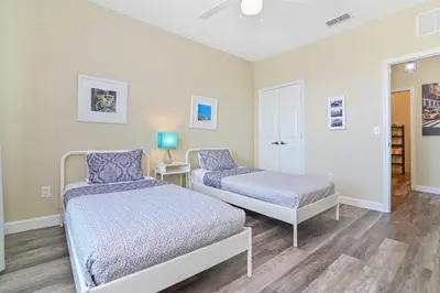 a bedroom with two beds and a mirror at SPECTACULAR CONDO only 4 Miles to Disney! in Kissimmee
