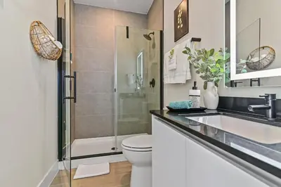 a bathroom with a shower and a toilet and a sink at Look Out over Nature - Unique FRESH Corner Home in Orlando