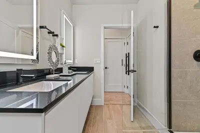 a white bathroom with a sink and a shower at Look Out over Nature - Unique FRESH Corner Home in Orlando