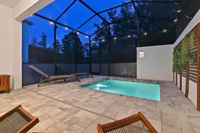 a swimming pool in a house with a glass ceiling at Look Out over Nature - Unique FRESH Corner Home in Orlando