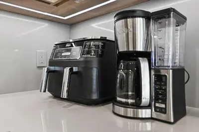 a coffee maker and a blender sitting on a counter at Discover paradise - NEW! Pool House Next to Disney in Orlando