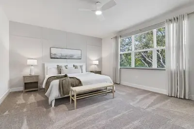 a white bedroom with a bed and a window at Discover paradise - NEW! Pool House Next to Disney in Orlando