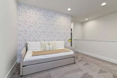 a bedroom with a bed and a wall with flowers at Oasis NEW Townhome Splash Pool Nature-Infused in Orlando