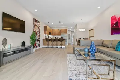 a living room with a couch and a table at Discover Your Escape - NEW house wPrivate Pool in Orlando