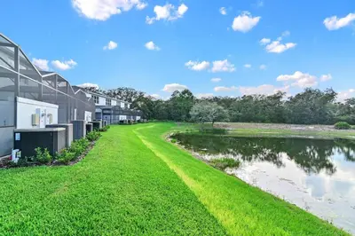 a view of the side of a building next to a body of water at Discover Your Escape - NEW house wPrivate Pool in Orlando