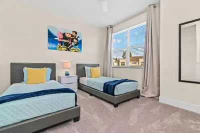 two beds in a bedroom with a window at Happiness is a destination ! - NEW house with pool in Orlando