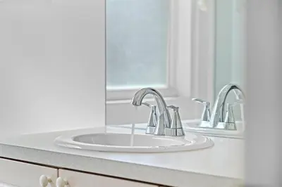 a bathroom with two sinks and a mirror at Windsor Palms 3BR FUN Retreat, Pool, Near Disney in Kissimmee