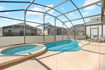 a swimming pool in a building with a glass roof at Windsor Palms 3BR FUN Retreat, Pool, Near Disney in Kissimmee