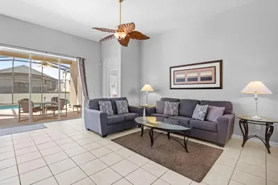 a living room with a couch and a table at Windsor Palms 3BR FUN Retreat, Pool, Near Disney in Kissimmee