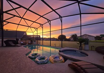 a swimming pool in a tent with a sunset at New Modern STAR WARS Villa Only 3 Miles 2 Disney w VR's in Kissimmee