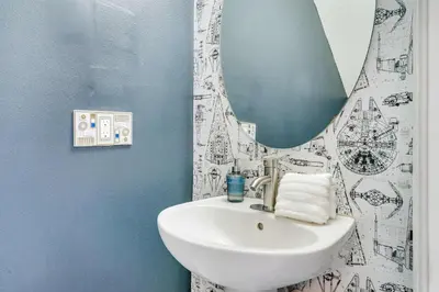 a bathroom with a sink and a mirror at New Modern STAR WARS Villa Only 3 Miles 2 Disney w VR's in Kissimmee
