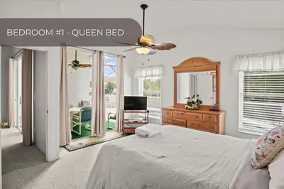 a bedroom with a bed and a dresser and a television at Cozy 3BR Family Home Minutes from Disney in Kissimmee