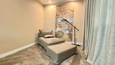 a room with a chair and a lamp in a room at Brand New Home with 4 En-Suites, near Disney in Kissimmee