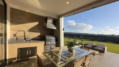 a kitchen with a glass table and a stove at Brand New Home with 4 En-Suites, near Disney in Kissimmee