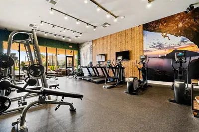 a gym with several treadmills and cardio machines at Brand New Home with 4 En-Suites, near Disney in Kissimmee