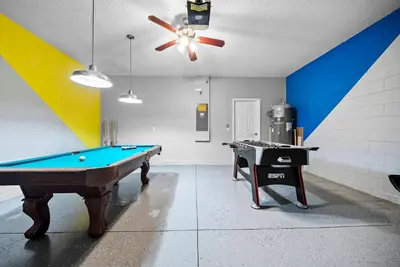 a room with a pool table and a ceiling fan at Amazing 08 BdrmsSleeps 14Pool in Kissimmee
