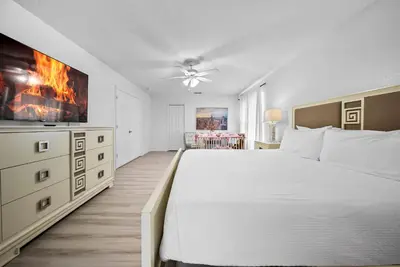 a bedroom with a large bed and a tv at Amazing 08 BdrmsSleeps 14Pool in Kissimmee