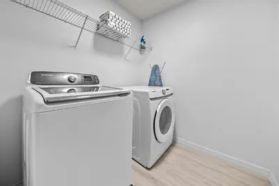 a washer and dryer in a laundry room at Amazing 08 BdrmsSleeps 14Pool in Kissimmee