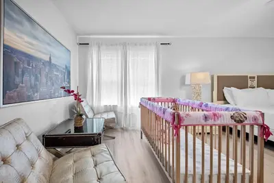 a baby room with a crib and a bed at Amazing 08 BdrmsSleeps 14Pool in Kissimmee