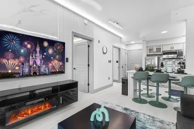 a living room with a fireplace and a tv at 1 bedroom apartment near Disney and Universal in Orlando