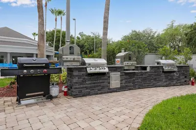 a barbecue grill in a brick wall in a yard at 1 bedroom apartment near Disney and Universal in Orlando