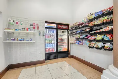 a grocery store aisle with a refrigerator and soda at 1 bedroom apartment near Disney and Universal in Orlando